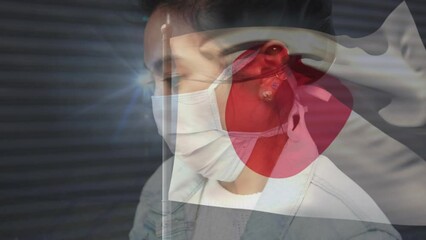 Wall Mural - Animation of flag of japan over asian woman with face mask