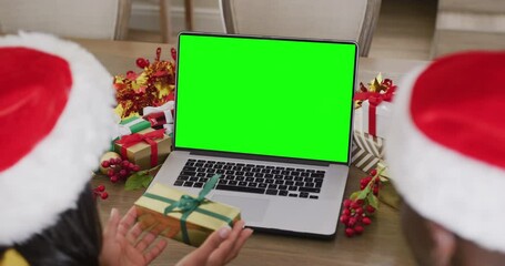 Sticker - Diverse couple with santa hats having laptop video call with copy space