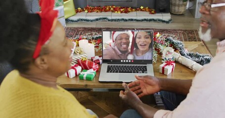 Poster - Animation of senior biracial couple on laptop video call with friends at christmas