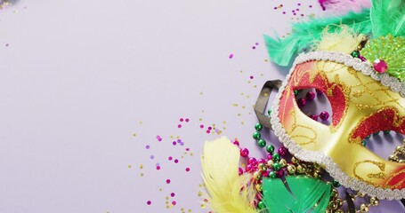 Wall Mural - video of carnival masquerade mask, feathers, confetti and mardi gras beads, with copy space