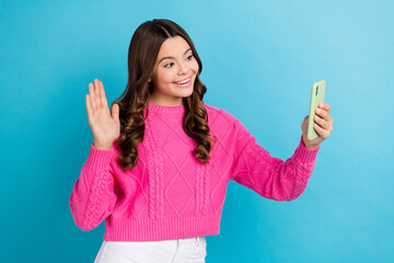 Canvas Print - Photo of youngster teen age school lady wear pink knitted pullover hold phone shooting smartphone palm greeting isolated on blue color background