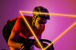 Triangle neon over determined biracial young male cyclist riding bicycle against pink background