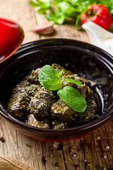 Poster - Dolma georgian kitchen with meat and mint on wooden table vertical