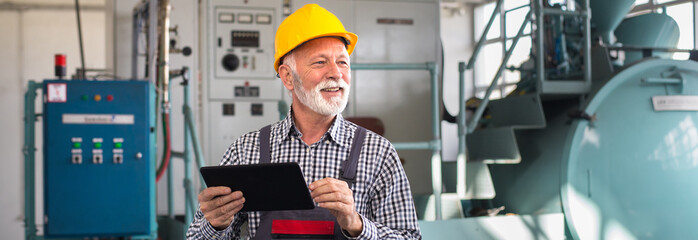 Senior man blue collar worker working in the factory