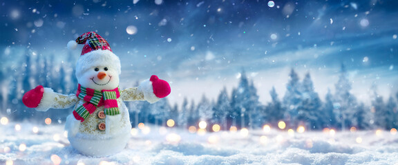 Wall Mural - snowman on snow in winter forest with snowfall in defocused landscape and abstract lights