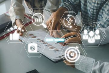 Monitoring process concept, Business person team analyzing income charts and graphs with monitoring process icon on virtual screen.