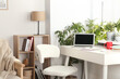 © New Africa - Stylish workplace with laptop on white desk near window