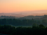 Fototapeta Na ścianę - Spring hills where the dawn breaks through the morning fog
