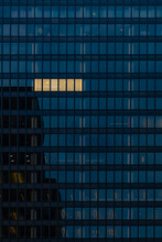 Working Late At Night Overtime, Office Building With One Set Of Windows Glowing