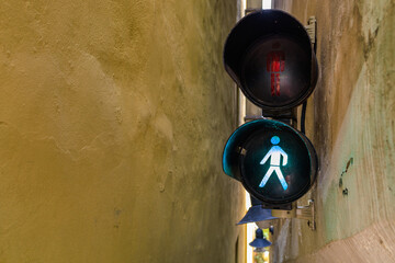 The narrowest pedestrian street in Prague with traffic lights and one-way traffic. Background