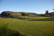 © Austockphoto - Flagstick on golf course green at headland