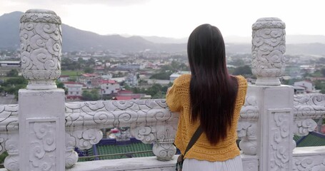 Wall Mural - Woman visit Taiwanese temple under sunset light flare