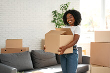 Happy African Young Woman With Cardboard Box Moving To A New Place