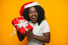 Beautiful African Girl With Christmas Gift Standing Against Yellow Background