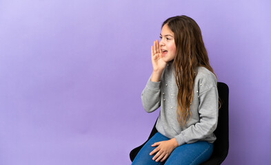 Poster - Little caucasian girl sitting on a chair isolated on purple background shouting with mouth wide open to the side