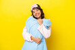 Young latin woman in pajamas isolated on yellow background