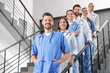 © New Africa - Team of professional doctors on staircase in clinic