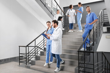 Sticker - Medical students wearing uniforms on staircase in college