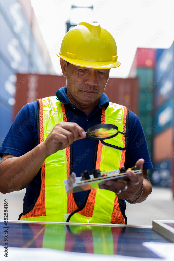 Foreman man  checking products at Container cargo harbor to loading containers. Professional foreman work at Container cargo site check up goods in container. Workers are opening containers for check.