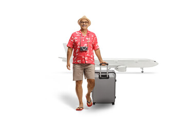 Poster - Full length portrait of a mature male tourist pulling a suitcase and arriving from a flight