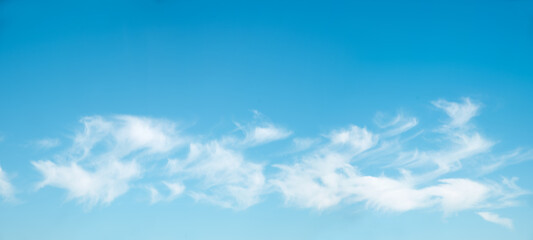 Wall Mural - blue sky background with fluffy cirrus clouds in the lower half
