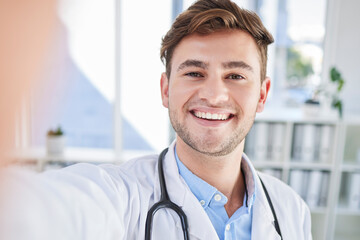 Wall Mural - Happy, portrait or doctor taking a selfie for a social media profile picture in a healthcare hospital on a break. Relaxing, man or face of medical worker taking pictures with pride or smile in office