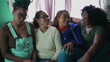 © Marco - Group of Brazilian women seated on couch hanging out together. South American adult girls at home. Latin people