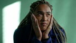 © Marco - One pensive young black woman in contemplation. Thoughtful African American pensive adult girl with dreadlocks closeup face
