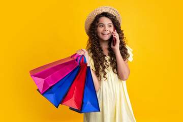 Poster - Stylish teen girl with shopping sale bags. Kid holding purchases. Happy teenager, positive and smiling emotions of teen girl.