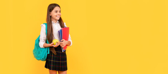 Wall Mural - schoolgirl with apple and backpack. back to school. teen girl ready to study. Portrait of schoolgirl student, studio banner header. School child face, copyspace.