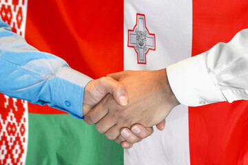 Wall Mural - Handshake on Belarus flag and flag of Malta background. Support concept