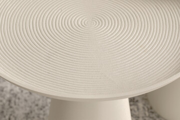 Close up of round metal textured coffee table