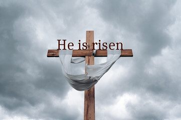 Wood cross on grey sky background with copy space for inscription. Good Friday, He is risen concept.