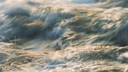 Wall Mural - Abstract timelapse video - long exposure shots of water flowing in river over rocks, afternoon sun shines on