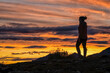 © Designpics - Silhouette of woman standing on a mountaintop enjoying the sunset near Dawson City; Yukon, Canada