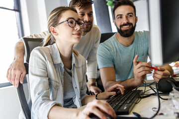 Group of programmers and game developers working on a new project at the office.	
