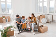© New Africa - Happy family sitting on couch in new apartment. Moving day