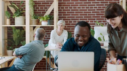 Poster - Business people, creative and modern office with laptop, conversation or startup company. Black man, team or entrepreneur with employee, woman and pc for marketing strategy, planning or communication