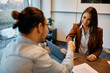 © Drazen - Happy businesswoman greeting candidate during job interview in office.