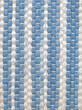 Closeup of handwoven rag rug in white and blue shades.