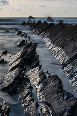 Wall Mural - Beautiful sunset landscape image of Welcome Mouth Beach in Devon England with beautiful rock formations
