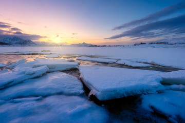Wall Mural - north, norway. winter landscape during sunset. bright sky. ice and snow on the shore. reflections on