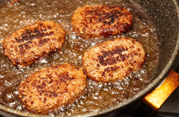 Poster - Cutlets are fried in oil in a frying pan.