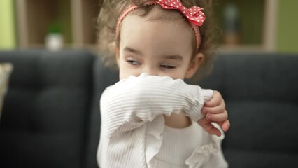 Sticker - Adorable caucasian girl kissing doll sitting on sofa at home