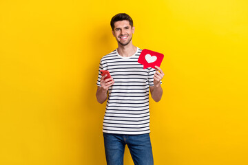 Poster - Portrait of positive person hold use telephone paper like card instagram twitter facebook isolated on yellow color background