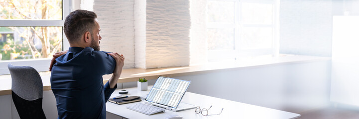 Poster - Employee Stretching At Office Desk