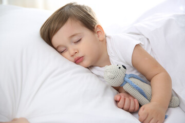 Cute little baby sleeping with toy at home. Bedtime