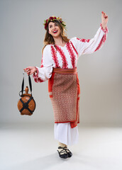 Wall Mural - Woman in Romanian traditional costume on gray