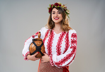 Wall Mural - Woman in Romanian traditional costume on gray