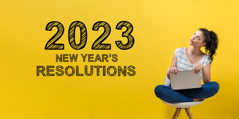 Wall Mural - 2023 New Years Resolutions with young woman using a laptop computer